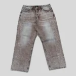 Grey washed denim jeans with large outlined vertical lettering on both legs and a relaxed straight-leg streetwear silhouette.