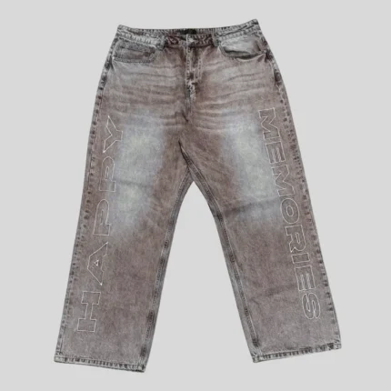 Grey washed denim jeans with large outlined vertical lettering on both legs and a relaxed straight-leg streetwear silhouette.