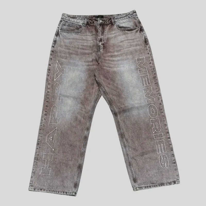 Grey washed denim jeans with large outlined vertical lettering on both legs and a relaxed straight-leg streetwear silhouette.