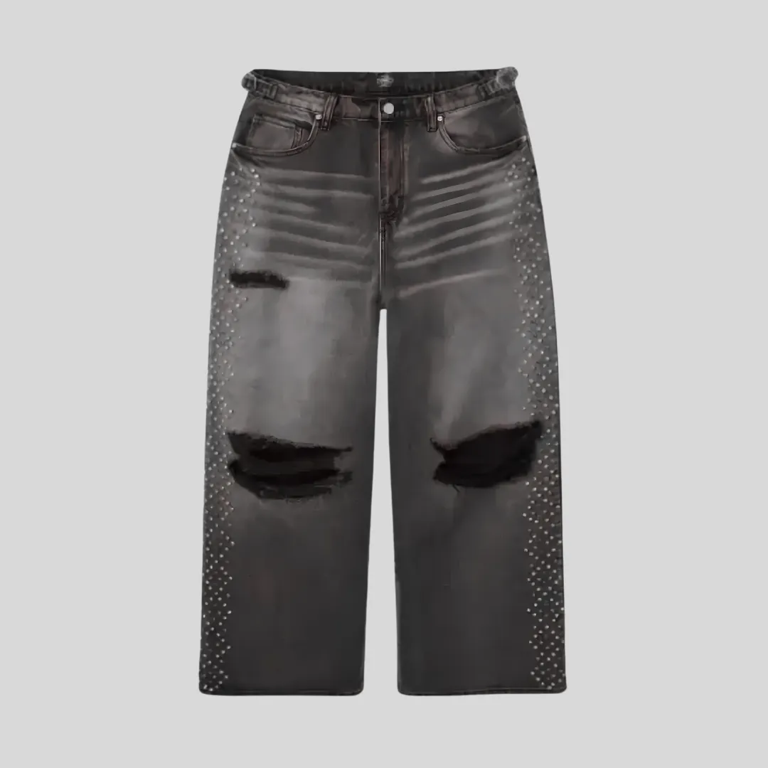 11 Black washed distressed jeans with large ripped knees, faded thigh detailing, and rhinestone embellishments running along both outer legs.