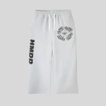 White relaxed-fit sweatpants with adjustable drawstring waist, black circular graphic on one upper leg and vertical black graphic on the opposite leg.