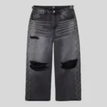 Black wide-leg distressed jeans featuring ripped knees, faded thigh detailing and rhinestone embellishments along both outer legs.