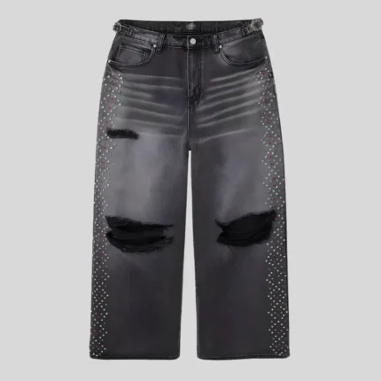 Black wide-leg distressed jeans featuring ripped knees, faded thigh detailing and rhinestone embellishments along both outer legs.
