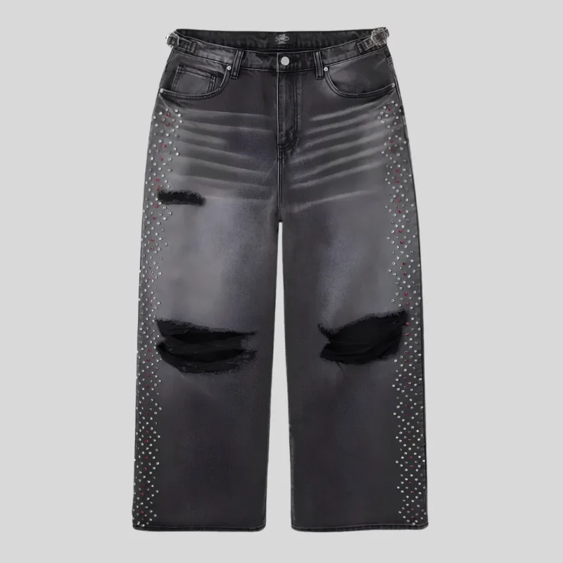 Black wide-leg distressed jeans featuring ripped knees, faded thigh detailing and rhinestone embellishments along both outer legs.