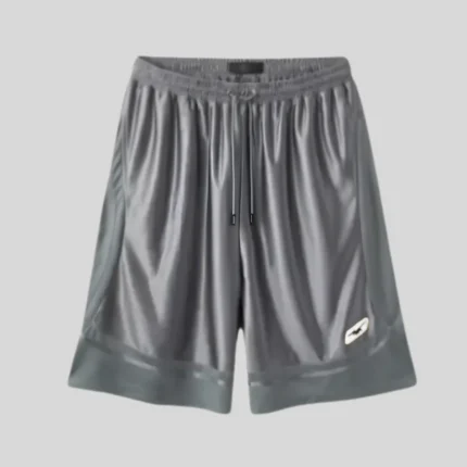 Charcoal grey wide-leg sweat shorts with elastic waistband, adjustable drawstring and subtle white side logo.