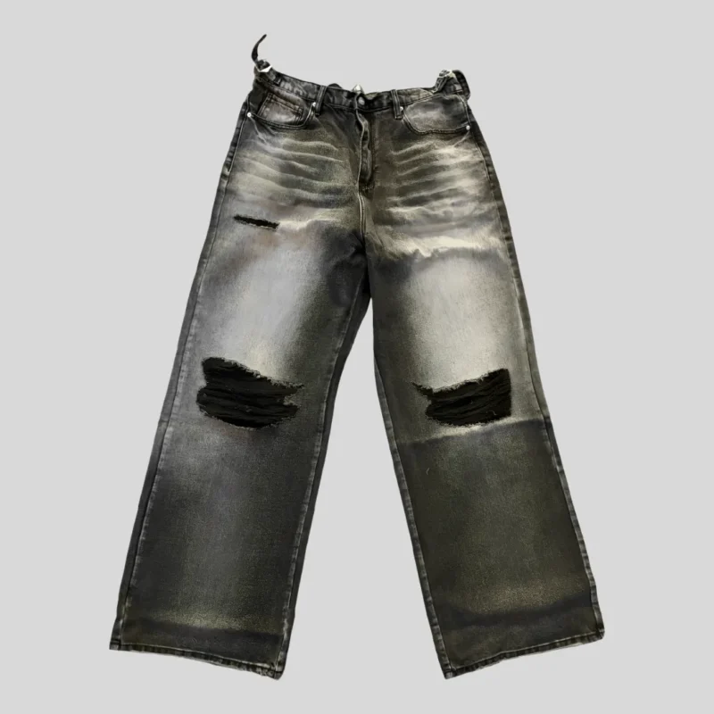 Black and charcoal washed distressed baggy jeans with faded thighs, ripped knees, belt loops, button fly and relaxed straight-leg silhouette.