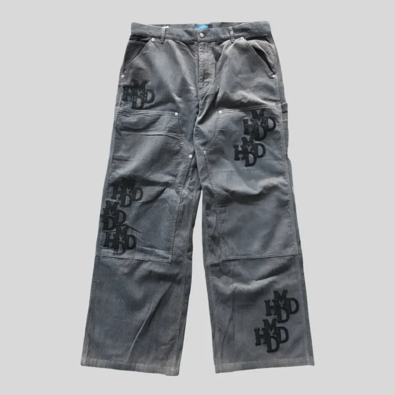 Grey wide-leg cargo pants with multiple utility pockets and tonal graphic details in a relaxed streetwear fit.