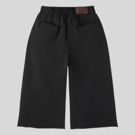 Black relaxed-fit sweatpants with multi-color rhinestone-style embellishments around the pockets and along the outer legs.