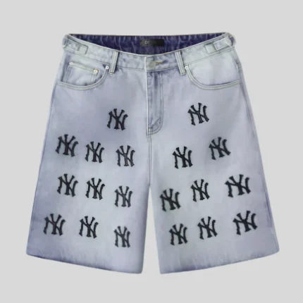 Light wash denim shorts with repeated black graphic embroidery-style motifs, classic front pockets, belt loops, button closure, and relaxed fit.
