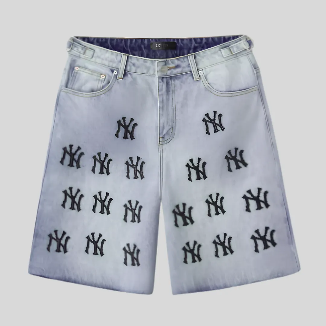 29 Light wash denim shorts with repeated black graphic embroidery-style motifs, classic front pockets, belt loops, button closure, and relaxed fit.