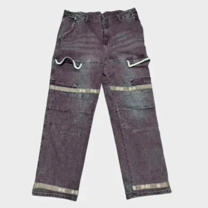Dark brown distressed utility jeans with layered patchwork panels, contrasting beige bands, curved trim details, belt loops, front pockets and relaxed straight-leg fit.
