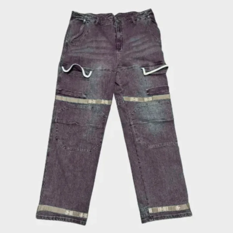 Dark brown distressed utility jeans with layered patchwork panels, contrasting beige bands, curved trim details, belt loops, front pockets and relaxed straight-leg fit.