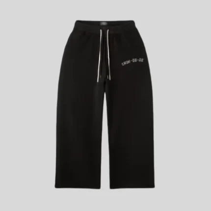 Black relaxed fit sweatpants with adjustable white drawstrings and subtle graphic text detail on the upper leg.