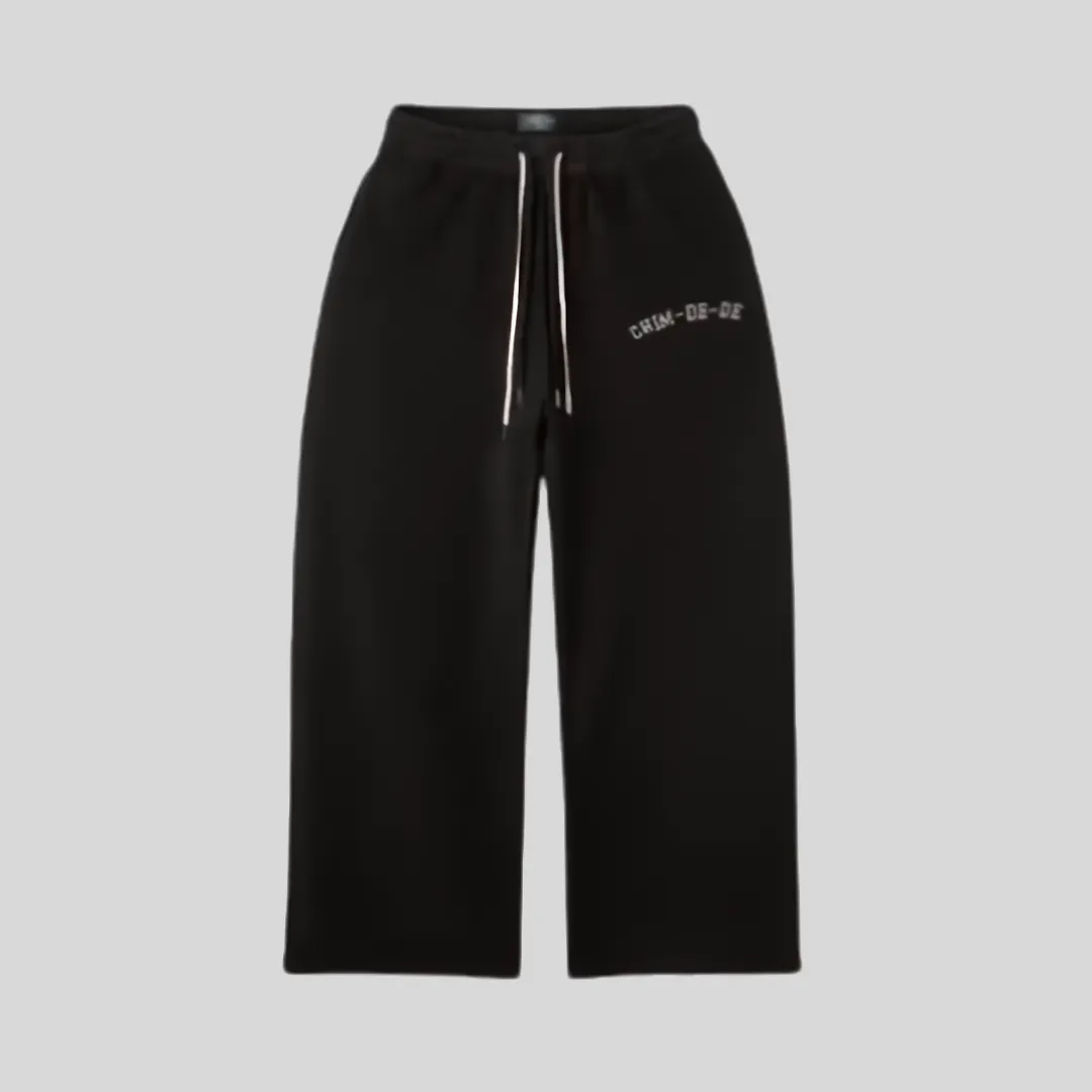 6 Black relaxed fit sweatpants with adjustable white drawstrings and subtle graphic text detail on the upper leg.