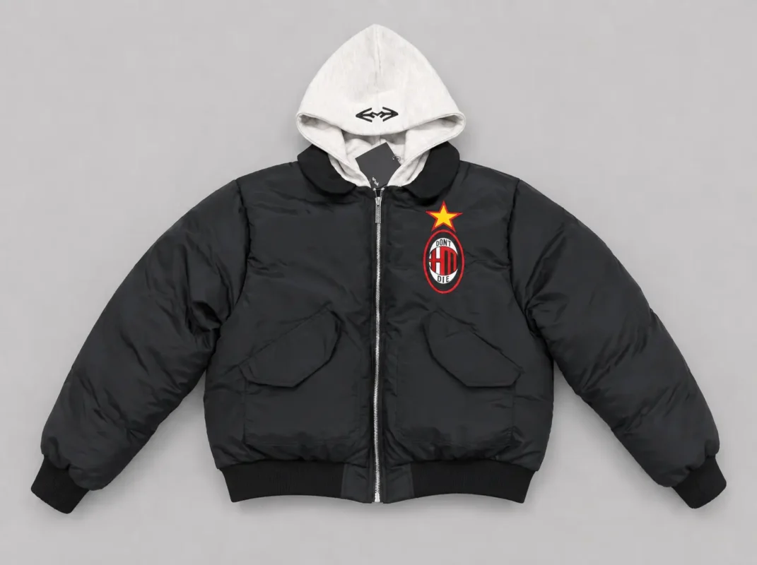 Black hooded bomber jacket with contrasting light hood, graphic chest emblem, front zipper, large utility pockets, ribbed cuffs and waistband.